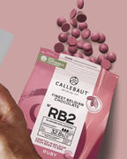 Callebaut Ruby chocolate packaging with chocolate pieces on a pink background
