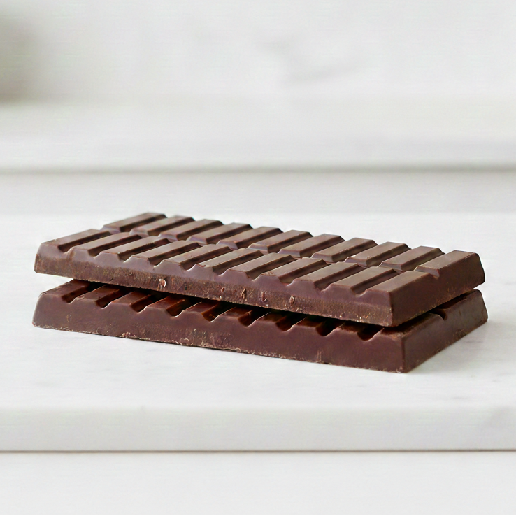 Chocolate bar on a white surface with a blurred background